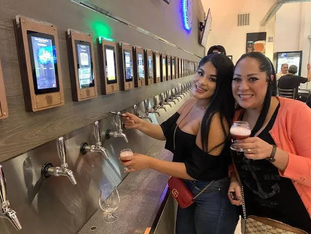 Guests enjoying the Barrel & Stave pour wall